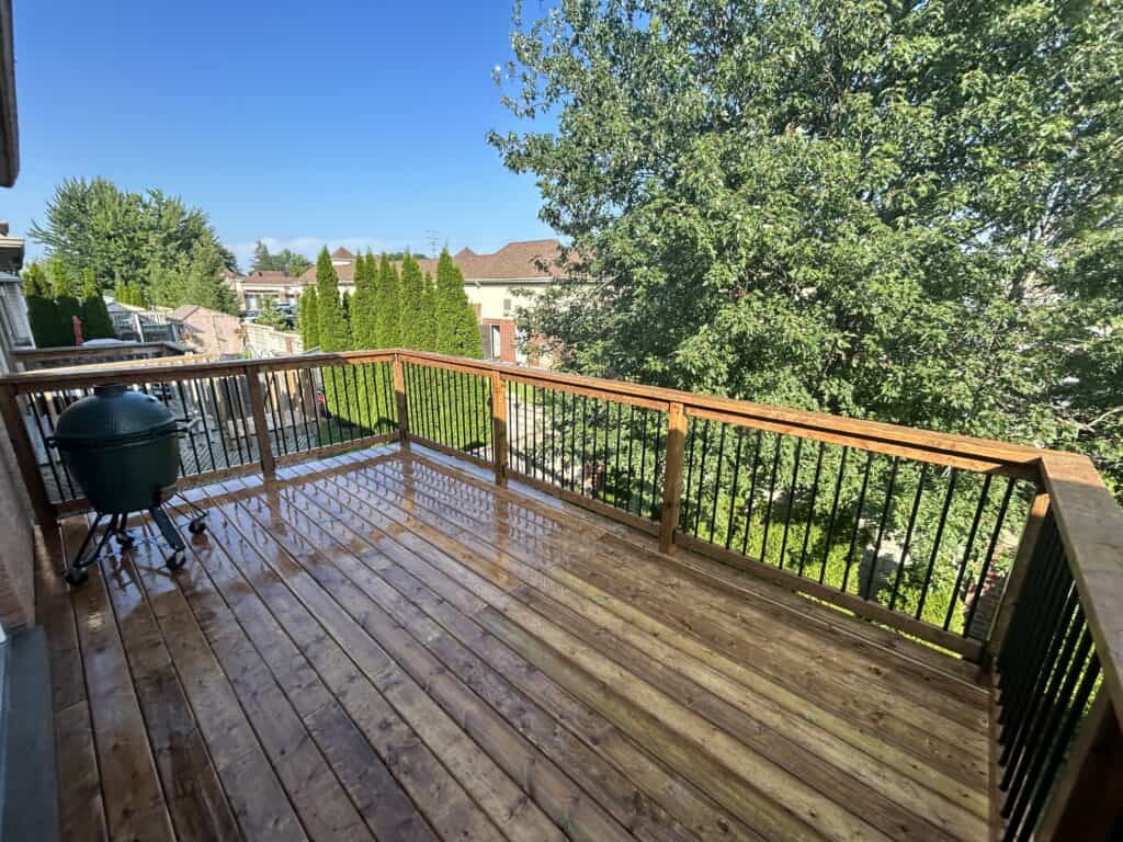 finished pressure treated wood deck with railings in Brampton Ontario